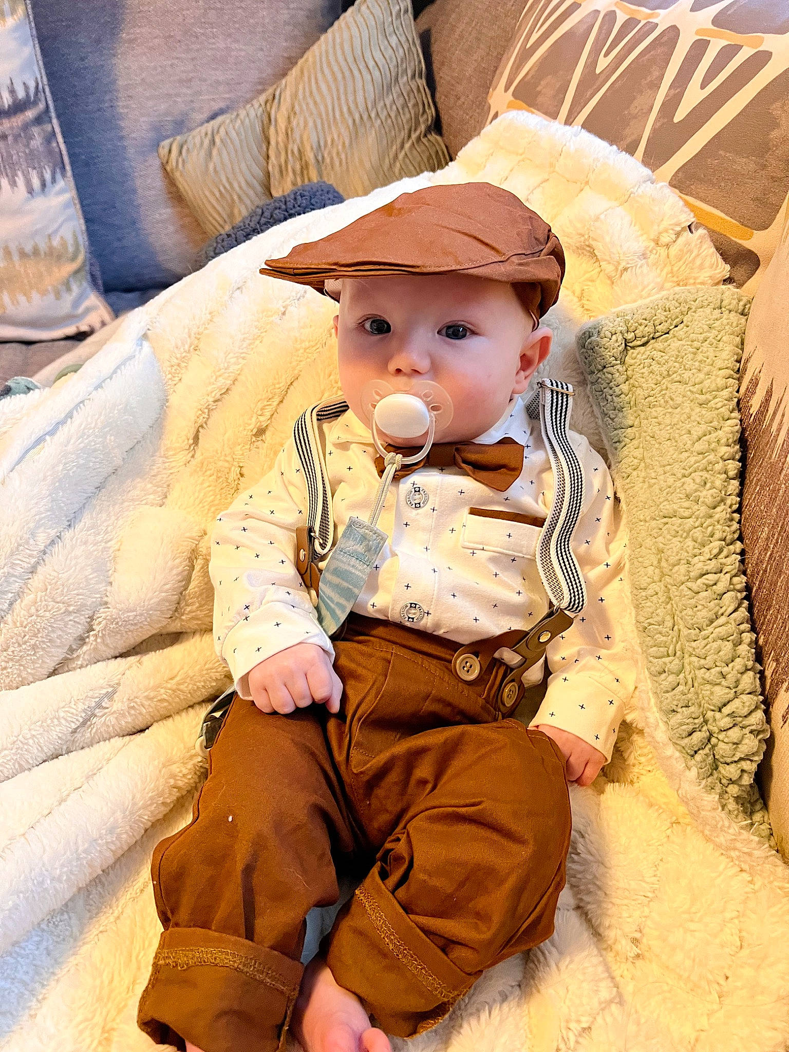 Jackson is registered to the contest to win money with this photo: baby, baby_products, baby_toddler_clothing, beige, cap, cheek, child, comfort, eye, fashion_accessory, hat, head, headgear, headwear, linens, person, sitting, skin, sleeve, sun_hat