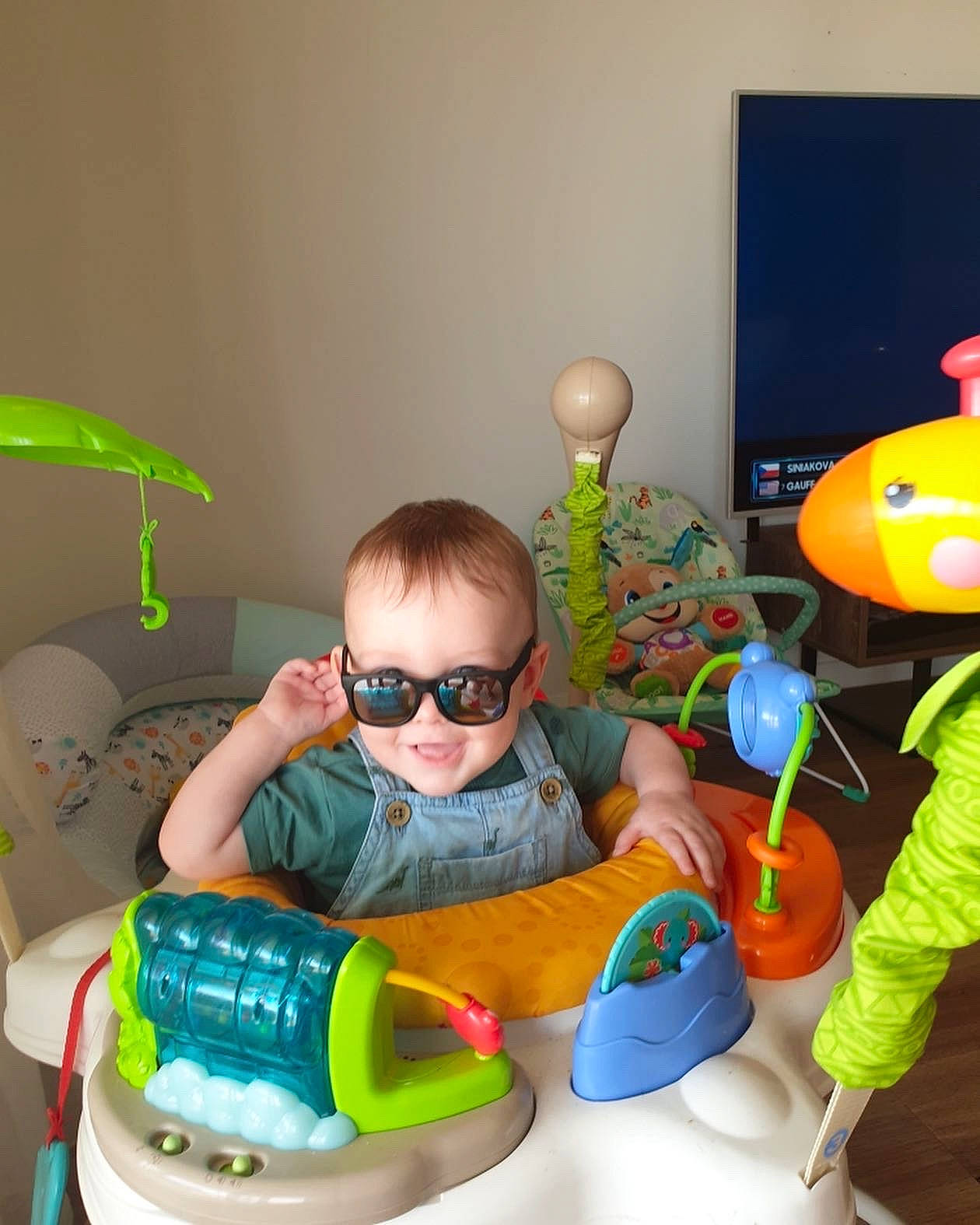 Archie is registered to the contest to win money with this photo: baby, baby_products, baby_toddler_clothing, baby_toys, chair, child, comfort, eyewear, fun, glasses, goggles, joy, person, plastic, play, room, sharing, sitting, sunglasses, toddler