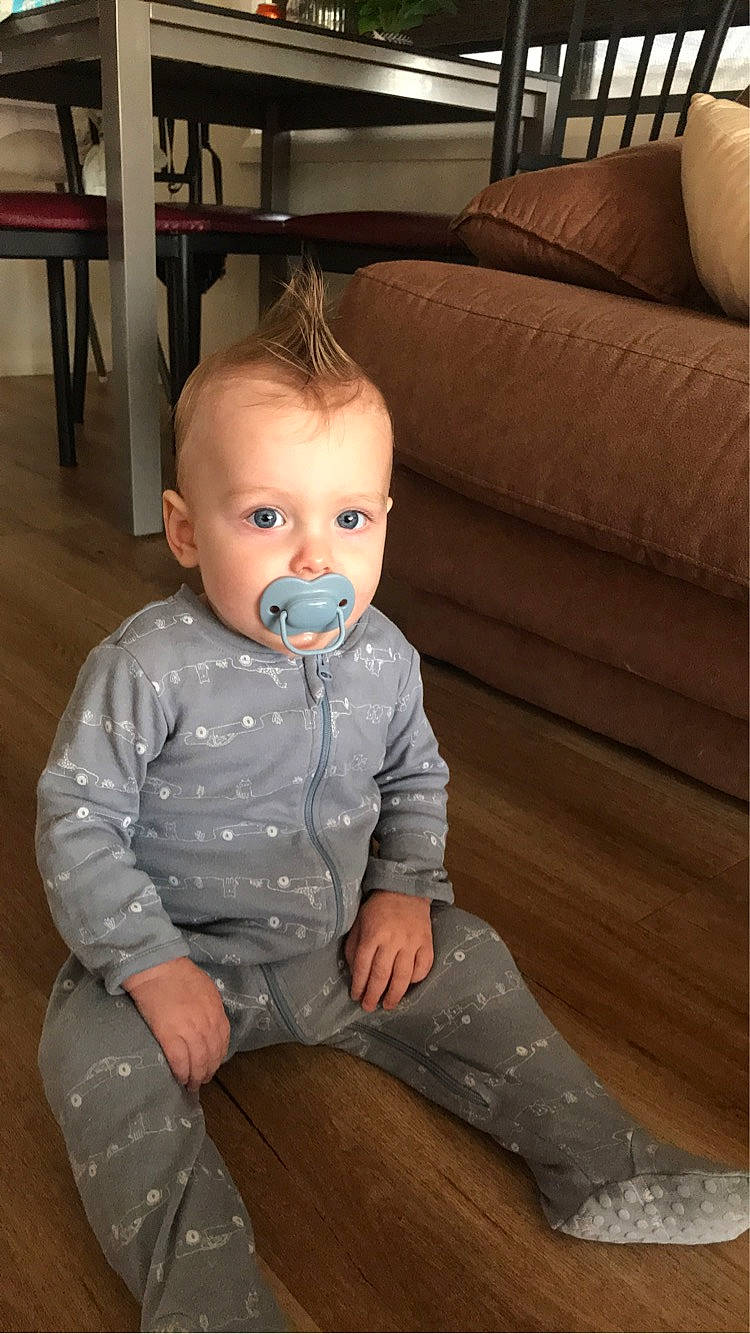 Archie is registered to the contest to win money with this photo: baby, baby_toddler_clothing, cheek, child, comfort, couch, dress_shirt, eye, facial_expression, floor, flooring, fun, hardwood, iris, person, sitting, skin, sleeve, toddler, white