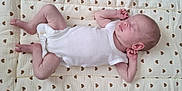 Jessie-June joined the competition — help win amazing prizes! baby, sleeping, infant, onesie, quilt, heart_pattern, peaceful, soft_texture, newborn, skin, lying_down, cute, resting, small_hands, small_feet, bedtime, nap, indoors, cozy, calm