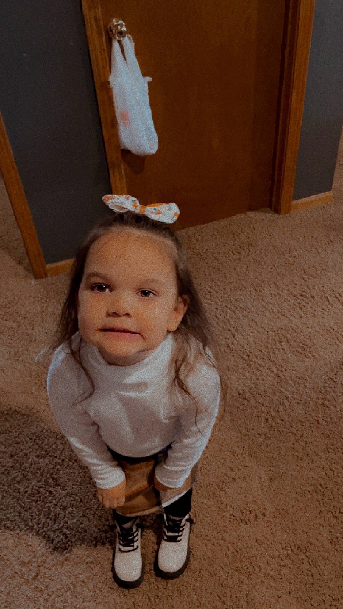 Elaine is registered to the contest to win money with this photo: baby, baby_toddler_clothing, brown_hair, cheek, eye, eyelash, face, fashion_accessory, flash_photography, flooring, hair, hardwood, human_leg, knee, person, sitting, sleeve, sock, thigh, toddler