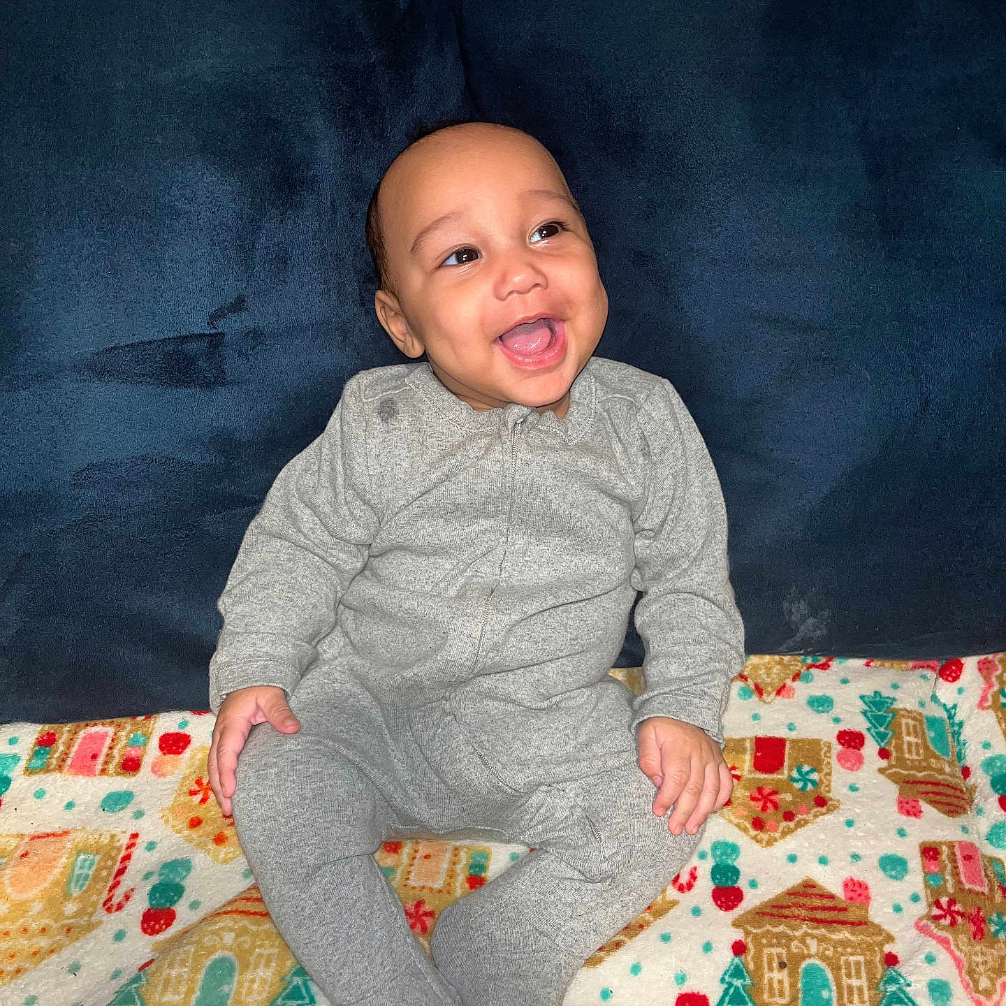 Demuir joined the competition — help win amazing prizes! baby, blanket, candy_cane, child, clothing, colorful, cozy, cute, face, gingerbread_house, gray_onesie, happy, holiday_theme, indoor, infant, joyful, plush, portrait, sitting, smiling