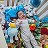 Zymir joined the competition — help win amazing prizes! baby, crib, toy_story, plush_toy, bedding, smiling, infant, colorful, child, stuffed_animal, sleepwear, happy, indoor, cushion, cartoon, person, bed, playful, cute, soft_toy