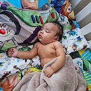 Zymir is registered to the contest to win money with this photo: baby, sleeping, blanket, bedding, toy_story, buzz_lightyear, toy, cartoon, child, crib, comfort, nursery, cute, infant, rest, pillow, colorful, soft, peaceful, relaxation