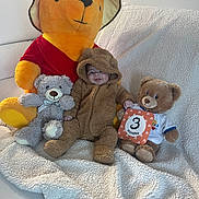 Junior Abdiel joined the competition — help win amazing prizes! baby, teddy_bear, stuffed_animal, plush, onesie, milestone_card, couch, blanket, smile, child, indoor, soft_toy, cute, baby_clothing, winnie_the_pooh, happy, sitting, fuzzy, infant, cozy