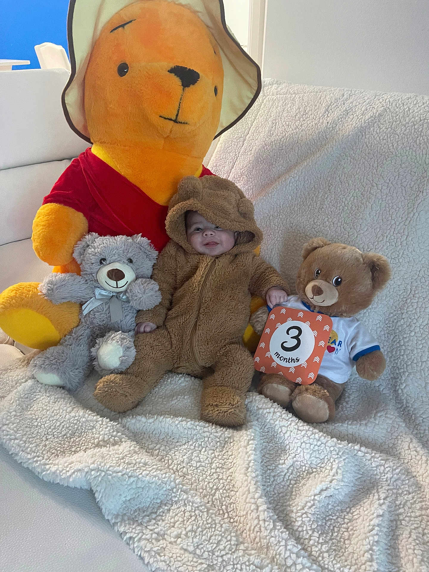 Junior Abdiel joined the competition — help win amazing prizes! baby, teddy_bear, stuffed_animal, plush, onesie, milestone_card, couch, blanket, smile, child, indoor, soft_toy, cute, baby_clothing, winnie_the_pooh, happy, sitting, fuzzy, infant, cozy