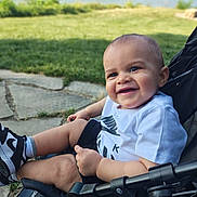 Aire joined the competition — help win amazing prizes! baby, child, smiling, stroller, outdoor, waterfront, grass, pavement, sneakers, black_and_white, happy, cute, person, summer, nature, casual_clothing, sunlight, face, head, legs