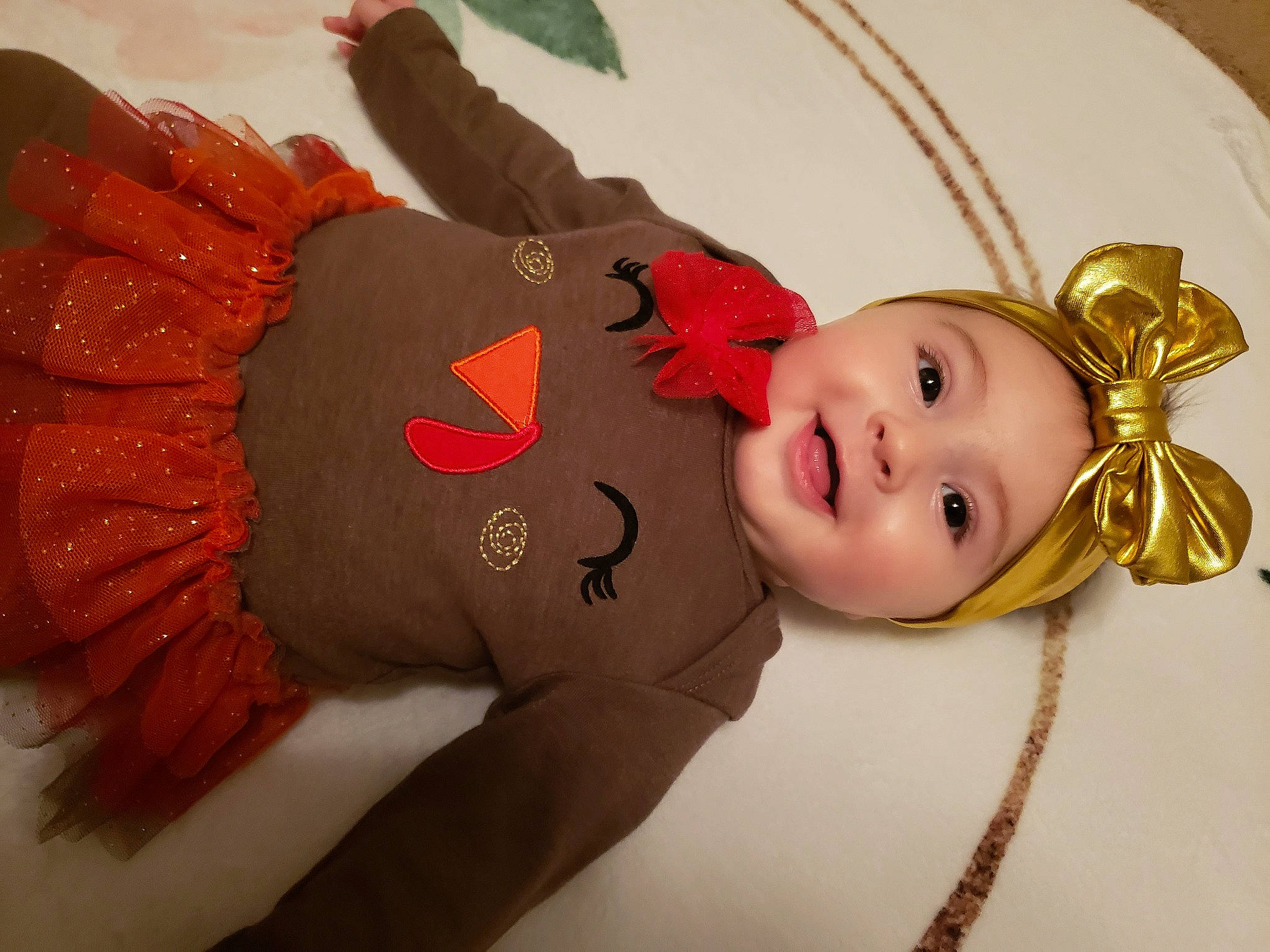 Skylar is registered to the contest to win money with this photo: baby, baby_products, baby_toddler_clothing, bird, child, costume, costume_accessory, costume_hat, fashion_accessory, hair_accessory, happy, head, headwear, jewellery, joy, person, pink, room, sleeve, smile