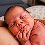 baby, sleeping, smile, hand, face, infant, cute, cozy, soft_lighting, closeup, skin, child, peaceful, portrait, indoors, clothing, resting, newborn, happy, expression