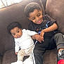 Jakory joined the competition — help win amazing prizes! baby, child, couch, siblings, smiling, happy, indoors, clothing, shoes, black_hair, curly_hair, white_shirt, black_pants, red_shoes, pacifier, family, holding_hands, seated, cute, toddler