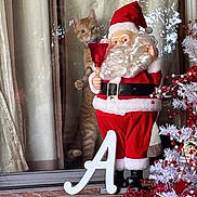 Woodstock joined the competition — help win amazing prizes! brick_wall, cat, celebration, christmas_tree, curtains, decorations, festive, holiday_decor, indoor, letter_a, orange_tabby, ornaments, red_bell, red_berries, reflection, santa_claus_figurine, seasonal, white_tree, window, wooden_crate