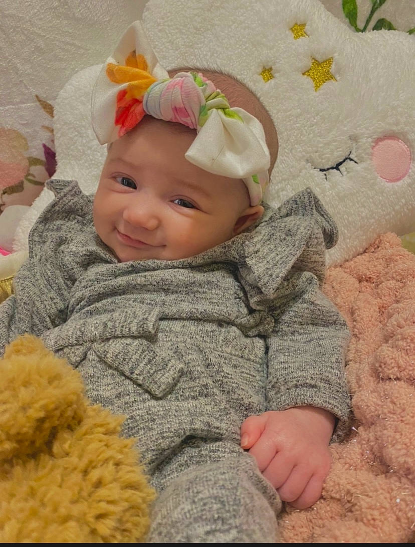 Nova is registered to the contest to win money with this photo: baby, baby_toddler_clothing, cap, cheek, child, clothing, comfort, facial_expression, fun, grass, happy, headgear, headwear, knit_cap, people_in_nature, person, skin, sleeve, smile, textile