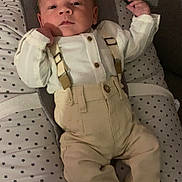 Mayronn participe au concours pour gagner de l'argent avec cette photo : baby, infant, suspenders, pants, cushion, star_pattern, clothing, person, indoor, face, head, hand, footwear, socks, relaxing, portrait, cute, newborn, fabric, soft