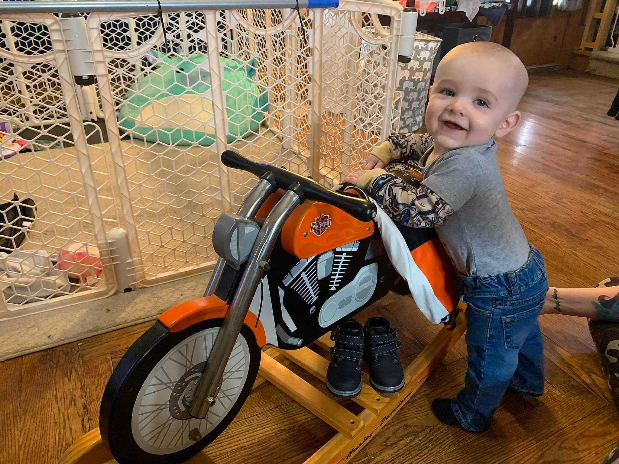 Danny is registered to the contest to win money with this photo: automotive_design, automotive_lighting, automotive_tire, automotive_wheel_system, baby, boot, happy, joy, motor_vehicle, motorcycle, person, recreation, rim, sitting, smile, spoke, street_fashion, tire, toddler, vehicle
