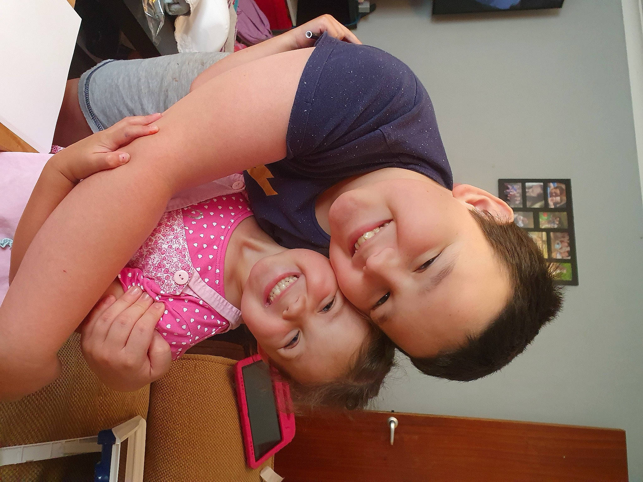 Toby is registered to the contest to win money with this photo: arm, black_hair, child, elbow, eyewear, facial_expression, finger, fun, gesture, happy, joint, joy, leg, mouth, neck, person, picture_frame, shorts, skin, smile