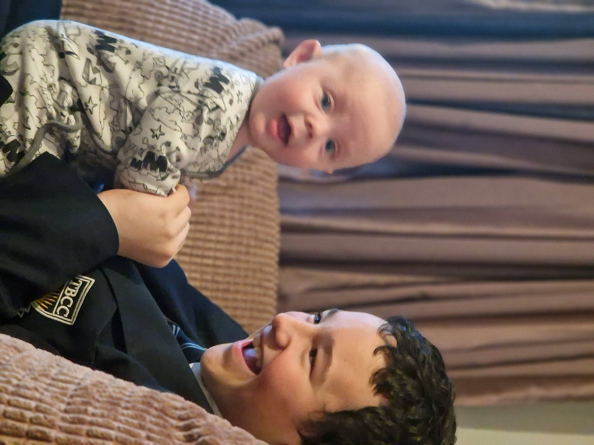 Archie is registered to the contest to win money with this photo: baby, cheek, child, comfort, eye, facial_expression, gesture, hairstyle, hand, happy, head, human, interaction, joy, mammal, organ, people, person, skin, smile