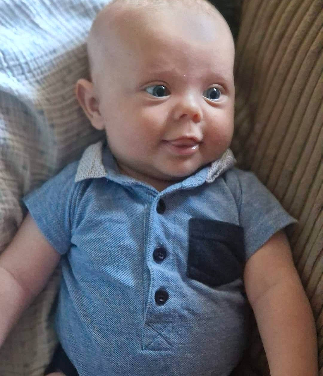 Archie is registered to the contest to win money with this photo: baby, baby_toddler_clothing, button, cheek, child, collar, comfort, dress_shirt, eyelash, grey, iris, lip, nose, person, sitting, skin, sleeve, smile, t_shirt, toddler
