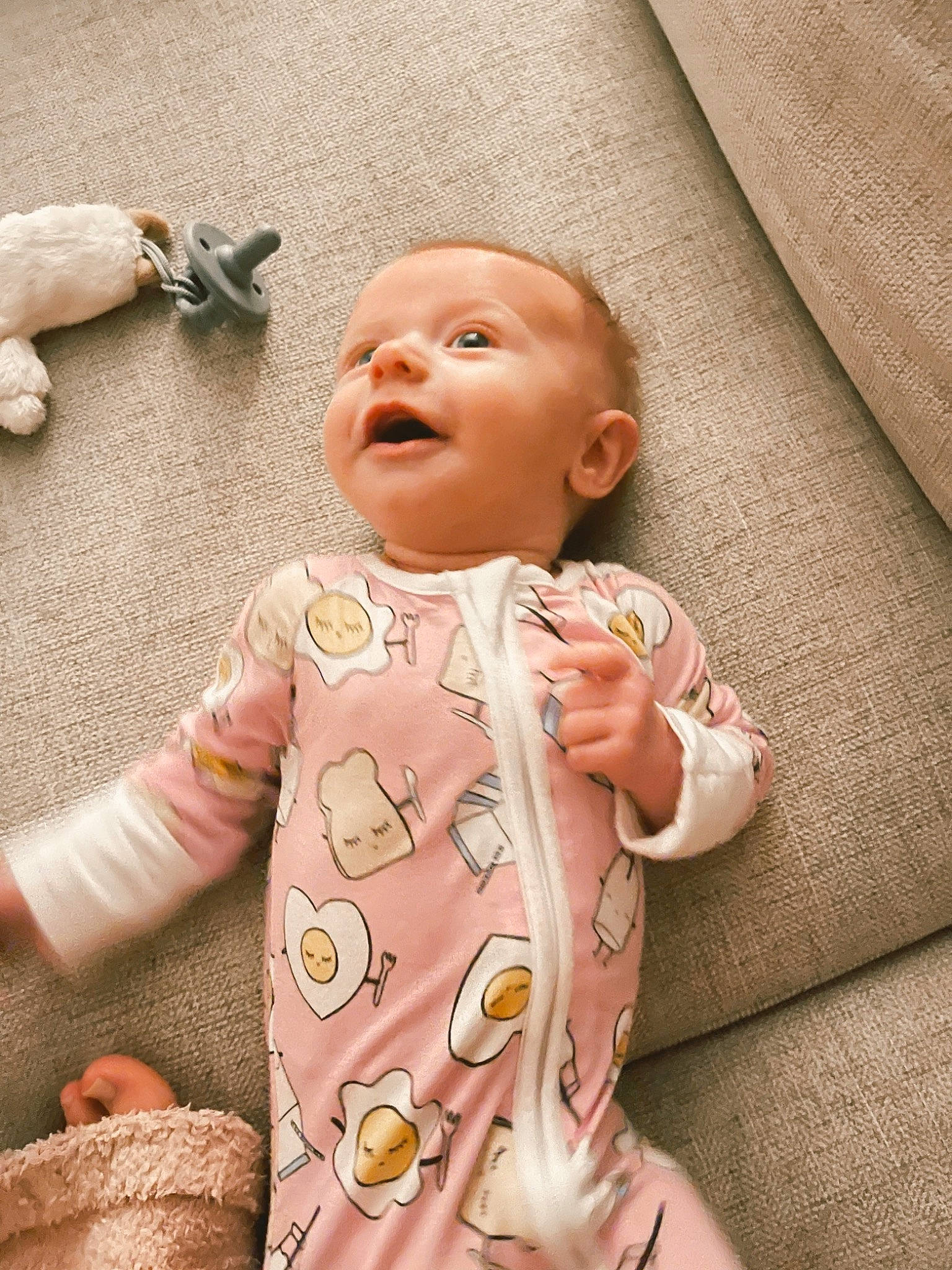 Violet is registered to the contest to win money with this photo: arm, baby, baby_toddler_clothing, cheek, comfort, eye, finger, gesture, head, human_body, joint, lip, mouth, nose, orange, person, pink, product, skin, sleeve