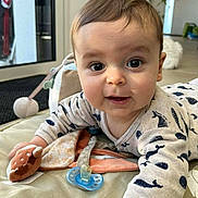 Louis a rejoint le concours — aidez-le/la à gagner de superbes lots ! baby, infant, crawling, whale_pattern, onesie, toy, pacifier, hand, face, eyes, smile, indoor, floor, blanket, child, cute, soft_toys, expression, young, curious