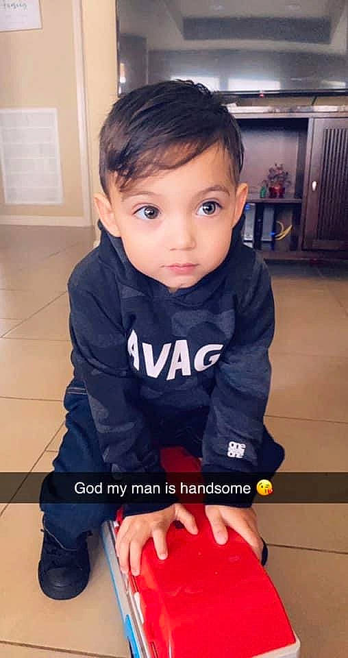 Danny is registered to the contest to win money with this photo: baby, baby_toddler_clothing, elbow, electric_blue, flooring, gadget, hair, happy, human_leg, knee, long_sleeved_t_shirt, neck, person, skin, sleeve, sportswear, standing, t_shirt, thigh, toddler