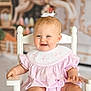 baby, infant, child, smiling, portrait, white_chair, pink_dress, bow, bib, cute, happy, blue_eyes, blond_hair, sitting, nursery, indoor, decor, furniture, face, closeup