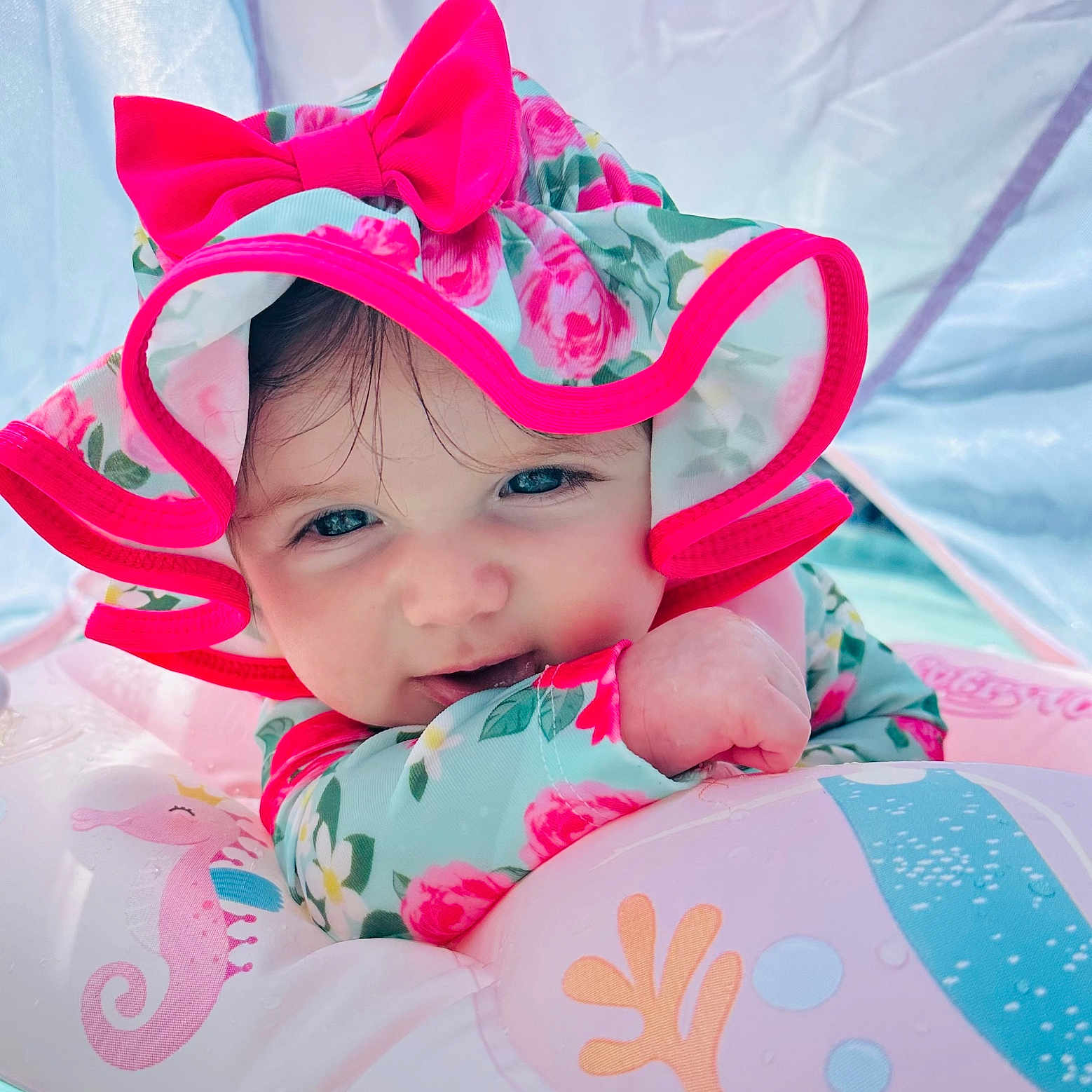Elodie joined the competition — help win amazing prizes! baby, bow, child, cute, face, float, floral, hat, inflatable, outdoor, pink, playful, pool, portrait, sea_horse, smile, summer, sunhat, toddler, water