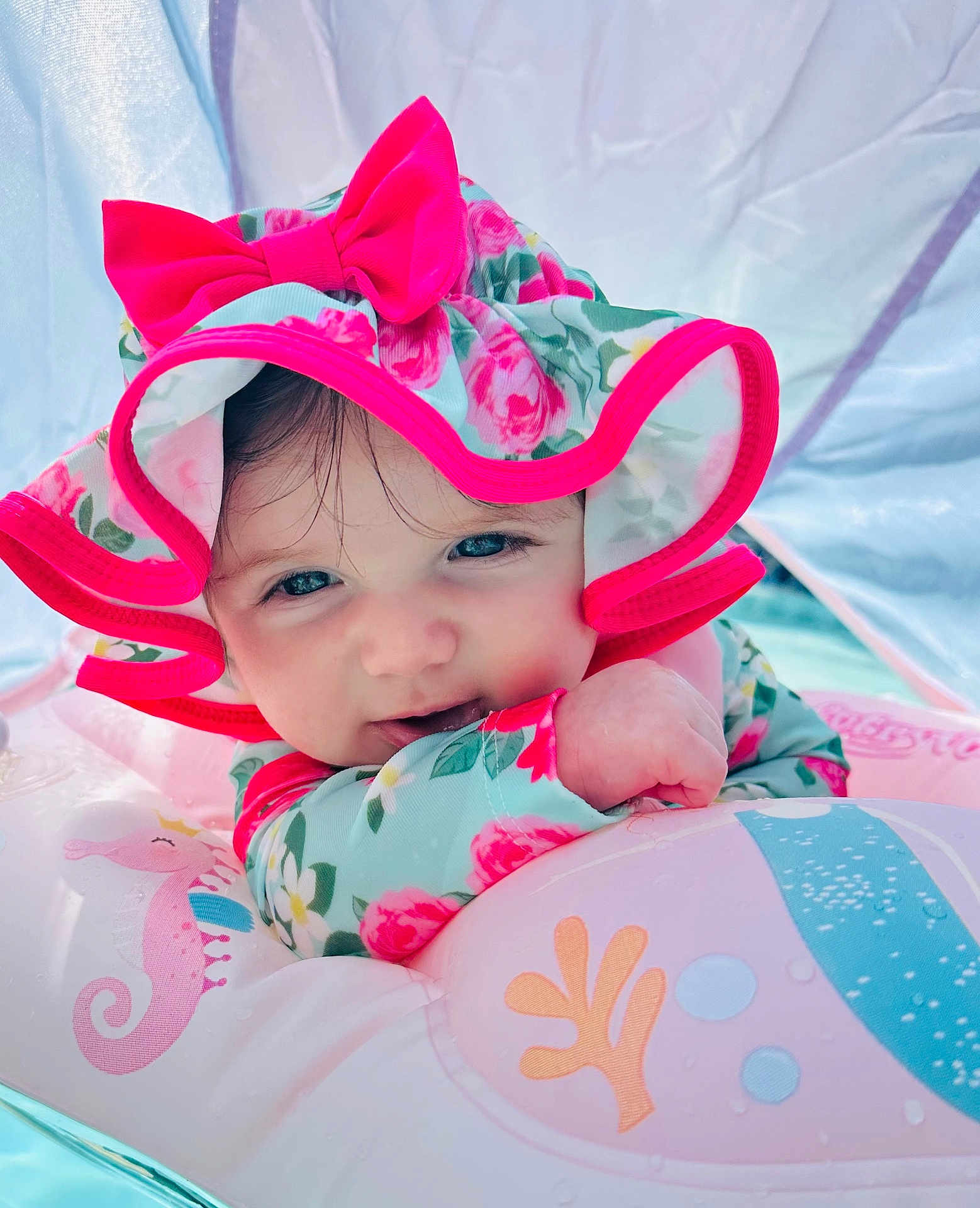 Elodie joined the competition — help win amazing prizes! baby, child, hat, pink, bow, floral, inflatable, pool, float, water, sea_horse, cute, smile, face, portrait, outdoor, sunhat, playful, summer, toddler