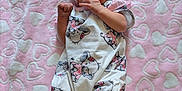 Willow is registered to the contest to win money with this photo: baby, infant, blanket, pink, hearts, headband, socks, clothing, cute, lying_down, soft, pattern, animal_print, koala, fabric, newborn, child, portrait, indoors, resting