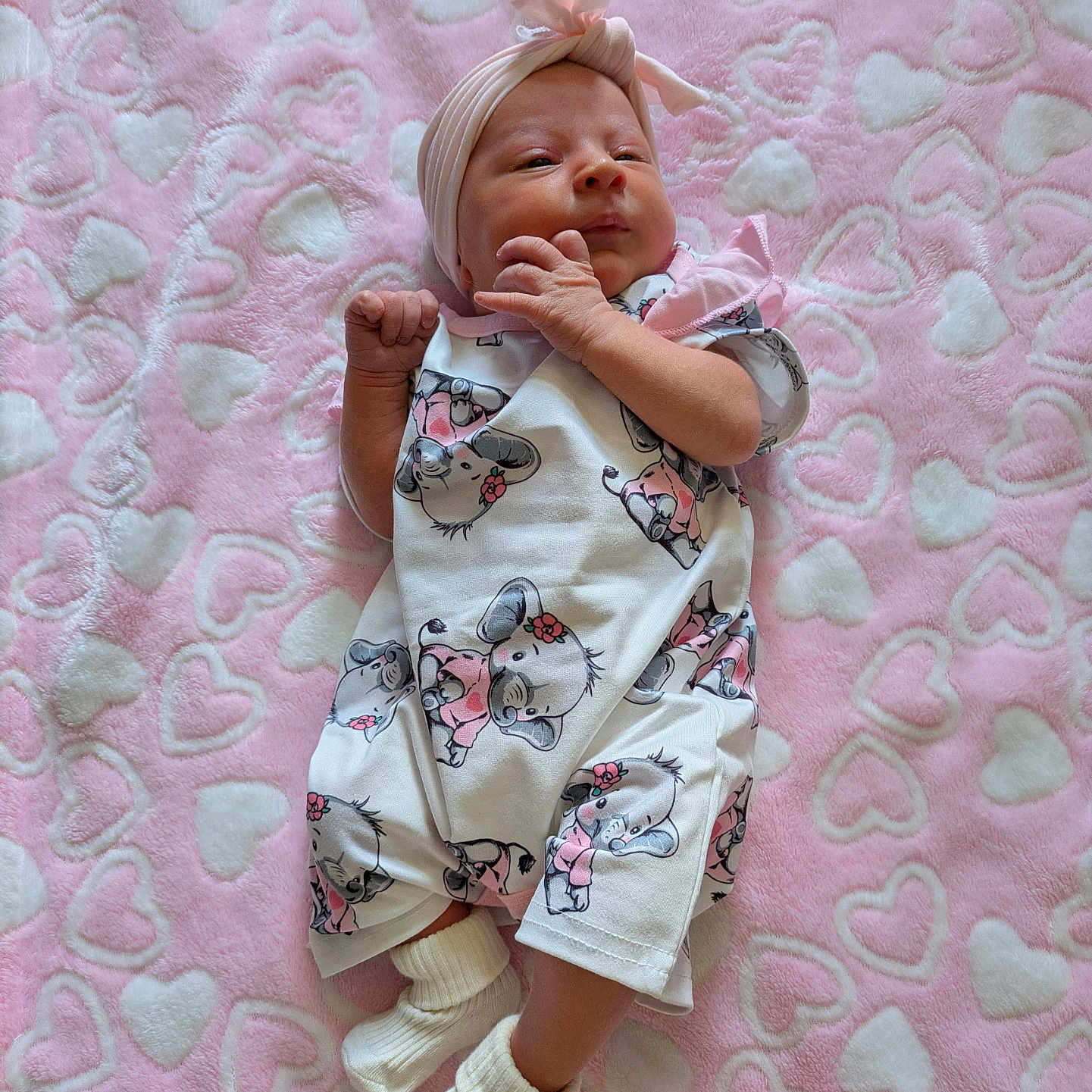 Willow is registered to the contest to win money with this photo: animal_print, baby, blanket, child, clothing, cute, fabric, headband, hearts, indoors, infant, koala, lying_down, newborn, pattern, pink, portrait, resting, socks, soft