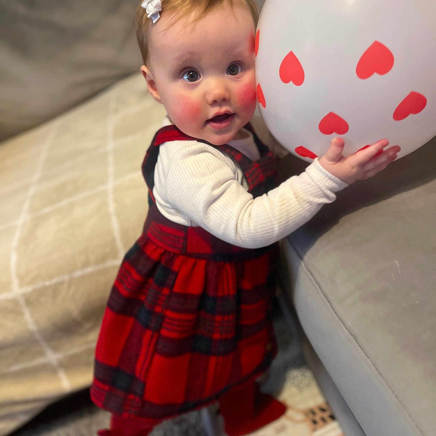 Ruby joined the competition — help win amazing prizes! baby, balloon, bodypart, clothing, costume, couch, dress, face, finger, footwear, furniture, hand, head, person, photography, portrait, shoe, skirt, sphere, tartan