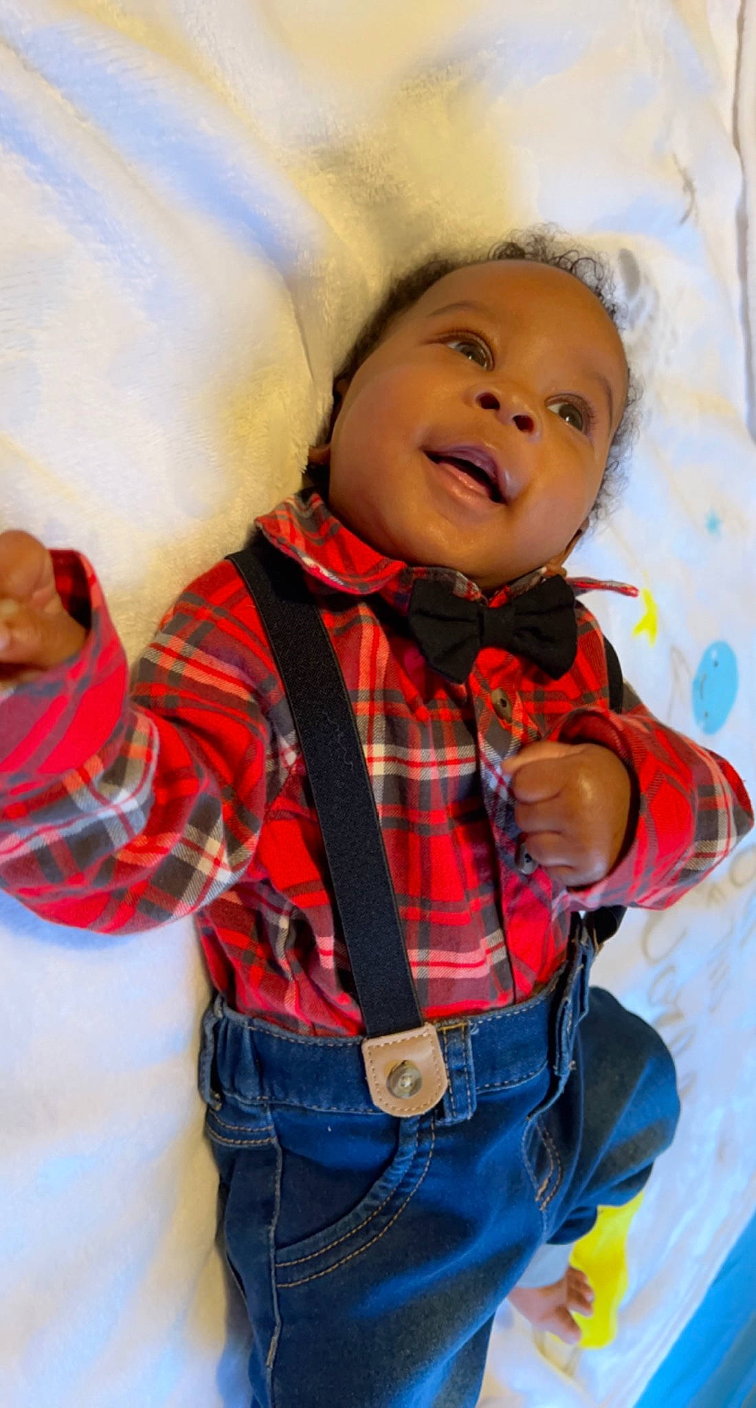 Hezekiah is registered to the contest to win money with this photo: baby, baby_toddler_clothing, cheek, child, clothing, collar, cool, face, happy, head, nose, orange, outerwear, pattern, person, plaid, sleeve, smile, tartan, textile