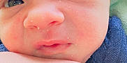 Fabian is registered to the contest to win money with this photo: baby, newborn, closeup, face, skin, arm, eyes, blanket, blue_clothing, resting, infant, soft_texture, curious, indoors, portrait, cute, child, newborn_baby, human, baby_skin