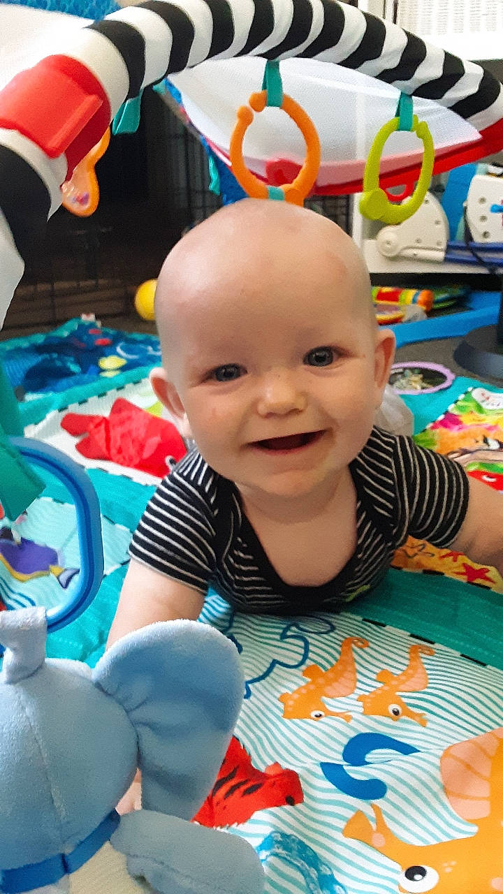 Brock is registered to the contest to win money with this photo: baby, baby_products, baby_toys, cheek, child, fun, head, joy, person, play, product, room, skin, smile, toddler, toy, tummy_time