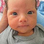 Francesco joined the competition — help win amazing prizes! baby, infant, face, eyes, curly_hair, shirt, hand, closeup, portrait, cute, newborn, child, skin, expression, person, young, indoors, soft_background, casual_clothing, looking