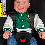 Pablo participe au concours pour gagner de l'argent avec cette photo : baby, child, car_seat, smiling, happy, denim, jacket, green_clothing, white_sleeves, safety_harness, pacifier, infant, cute, rosy_cheeks, indoor, portrait, seated, clothing, closeup, person