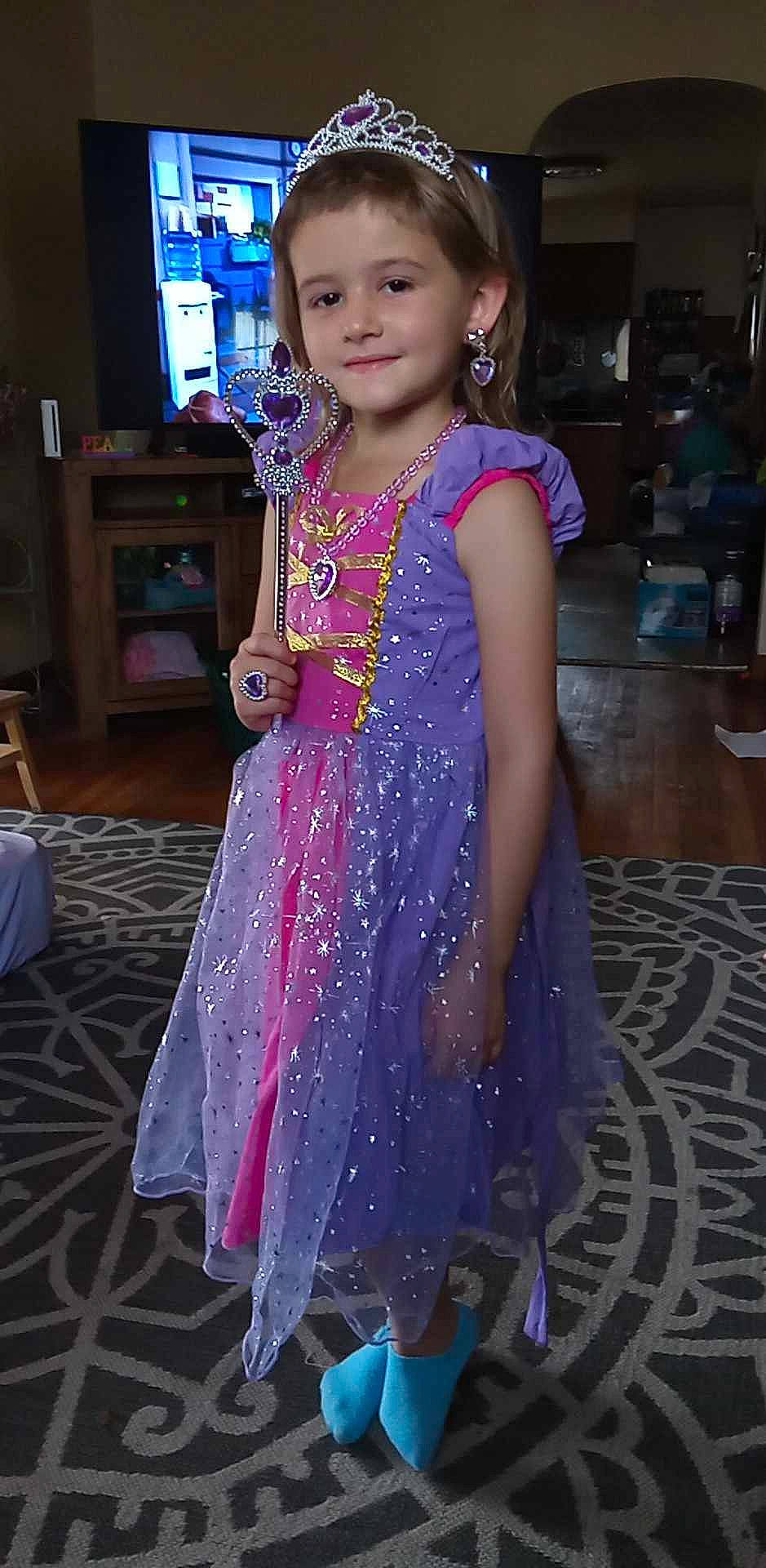 Tatyana is registered to the contest to win money with this photo: child, costume, dress, electric_blue, event, fashion_accessory, fashion_design, flooring, formal_wear, fun, happy, jewellery, joy, magenta, necklace, pattern, person, purple, smile, television