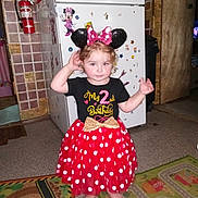 Alice joined the competition — help win amazing prizes! barefoot, birthday, black_shirt, child, curly_hair, decorations, doorway, fire_extinguisher, floor_mat, headband, indoor, kitchen, minnie_mouse, play_mat, polka_dot, red_skirt, refrigerator, toddler, toy_magnets, wall_art