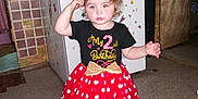 Alice joined the competition — help win amazing prizes! barefoot, birthday, black_shirt, bow, child, costume, curly_hair, cute, ears, fire_extinguisher, floor_mats, gold_bow, headband, indoor, kitchen, minnie_mouse, polka_dots, red_skirt, refrigerator, toddler
