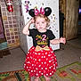 barefoot, birthday, black_shirt, bow, child, costume, curly_hair, cute, ears, fire_extinguisher, floor_mats, gold_bow, headband, indoor, kitchen, minnie_mouse, polka_dots, red_skirt, refrigerator, toddler