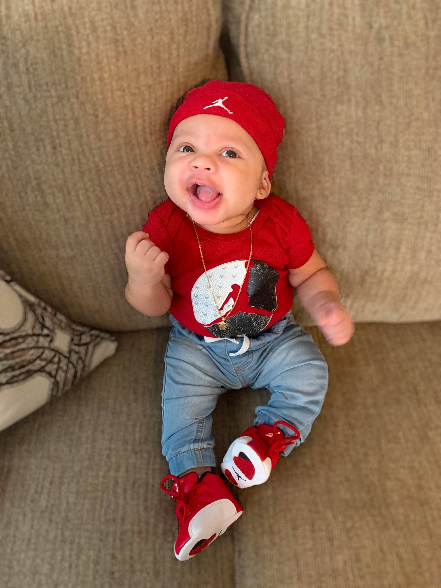 Kyngston is registered to the contest to win money with this photo: baby, baby_toddler_clothing, child, footwear, headgear, person, photography, play, red, shoe, sitting, skin, smile, toddler