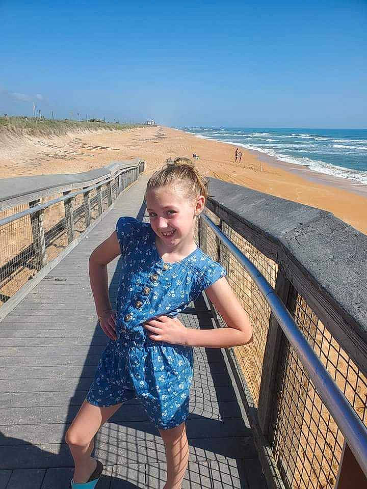 Rre is registered to the contest to win money with this photo: azure, beach, beauty, body_of_water, dress, fence, fun, happy, horizon, joy, leisure, light, line, people_in_nature, person, photograph, sky, smile, summer, travel