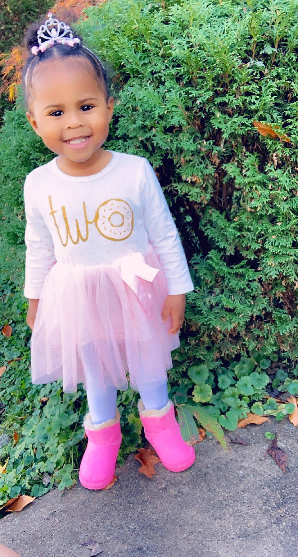 Karsen is registered to the contest to win money with this photo: baby_toddler_clothing, child, day_dress, face, fashion_accessory, grass, green, groundcover, happy, joy, magenta, outerwear, pattern, people_in_nature, person, pink, plant, purple, sleeve, smile