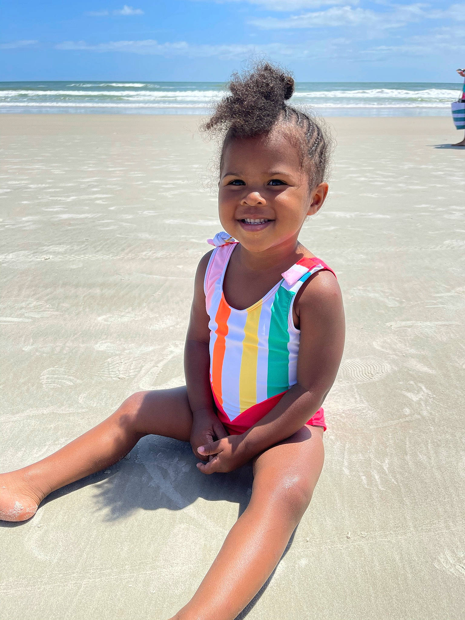 Karsen is registered to the contest to win money with this photo: baby_toddler_clothing, barefoot, beach, cloud, electric_blue, eye, fun, happy, joy, leg, leisure, people_on_beach, person, sand, shore, skin, sky, smile, thigh, toddler