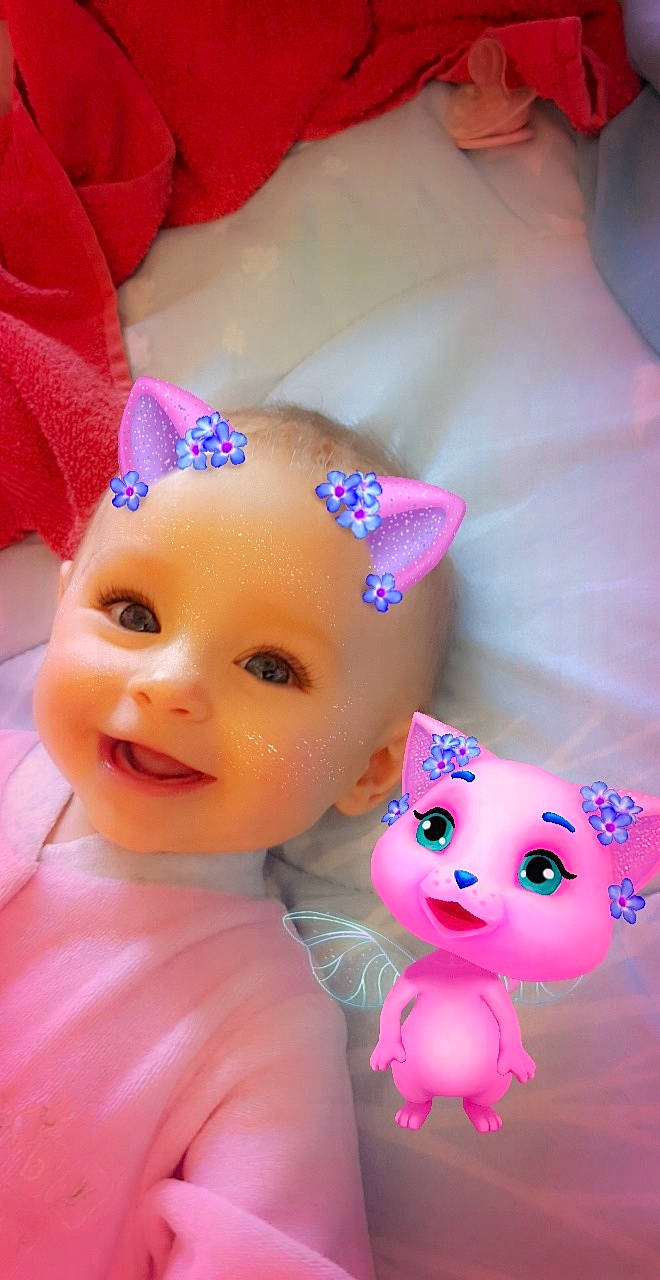 Louana participe au concours pour gagner de l'argent avec cette photo : baby, baby_toys, cheek, doll, dress, ear, eyelash, fashion_accessory, fawn, headwear, joy, magenta, mammal, party_hat, person, pink, purple, skin, textile, toy