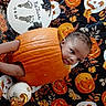 toddler, pumpkin, halloween, baby, blanket, orange, face, child, holiday, decor, festive, cute, autumn, jack_o_lantern, pattern, smiling, playful, indoors, young_child, celebration
