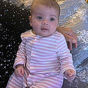 Metiem joined the competition — help win amazing prizes! baby, infant, pink_stripes, quilt, hand, adult_hand, person, indoor, clothing, bedroom, fabric, pattern, sleepwear, cute, newborn, face, sitting, portrait, soft_lighting, young_child