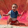 Jaxsyn is registered to the contest to win money with this photo: baby, child, infant, smiling, happy, sitting, portrait, face, outdoor, colorful, coral, shell, aquarium, attraction, bib, shirt, red_shorts, barefoot, background, photography