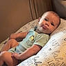 Jaxsyn joined the competition — help win amazing prizes! baby, infant, child, sitting, cushion, pillow, onesie, clothing, portrait, indoors, living_room, furniture, face, eyes, smile, baby_bottle, relaxed, photography, soft_lighting, home