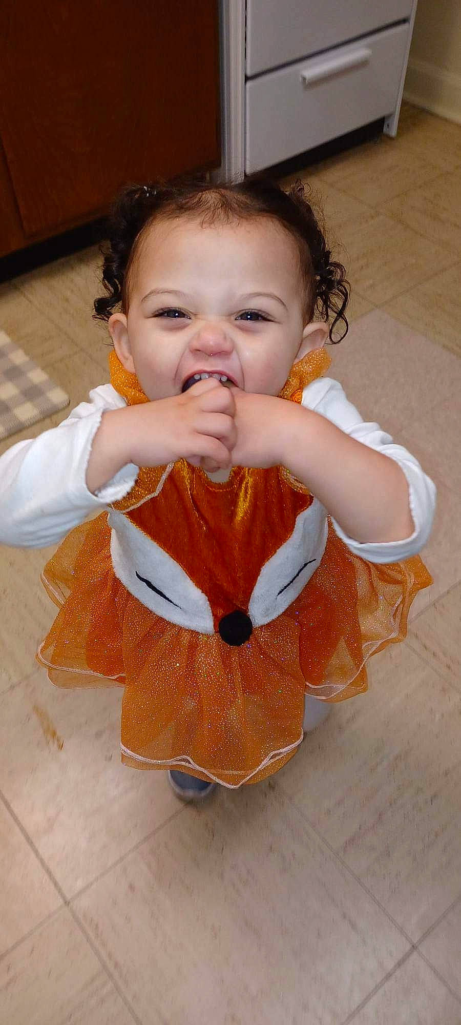 Henley is registered to the contest to win money with this photo: baby, baby_toddler_clothing, cheek, child, eye, eyelash, face, finger, flooring, gesture, hair, hand, happy, iris, neck, nose, orange, person, skin, sleeve