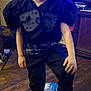 William is registered to the contest to win money with this photo: child, smile, football_helmet, barefoot, black_clothing, indoor, wooden_floor, television, furniture, door, toy, helmet, face, person, pants, short_hair, living_room, sports_equipment, happy, casual